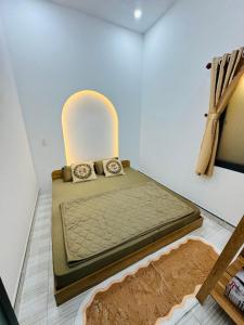 a bed sitting in a room with at N&N Family in Ngân Hà