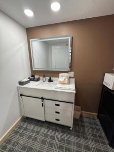 a bathroom with a white sink and a mirror at Suite 102 in Lusk