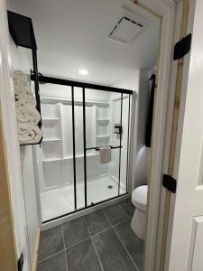 a bathroom with a shower and a toilet at Suite 102 in Lusk
