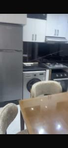 a kitchen with a table and chairs and a stove at Kelibia in Kelibia
