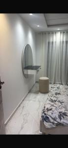 a bedroom with a bed and a mirror on the wall at Kelibia in Kelibia