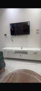 a flat screen tv hanging on a white wall at Kelibia in Kelibia