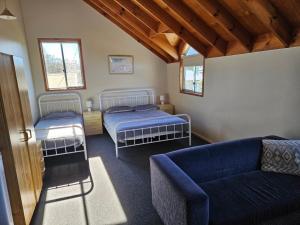 a living room with two beds and a couch at Billungar Unit 1 at Hat Head - 1 Creek Street in Hat Head