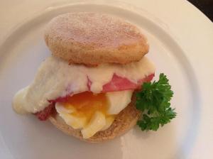 a sandwich on a white plate with a donut at Fring House Bed and Breakfast in Seaton