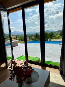 a room with a window looking out at a pool at Villa Kovacevic 2 in Bihać