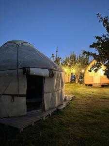 a person is sitting inside of a tent at Nomads Home in Tong