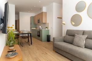 a living room with a couch and a table at Apartamentos Liérganes Centro II in Liérganes