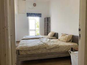 a bedroom with a bed and a window at Beit Rifi Mountain Escape, with intex pool, Feitroun in Al ‘Aqabah