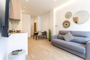 a living room with a blue couch and a table at Apartamentos Liérganes Centro II in Liérganes