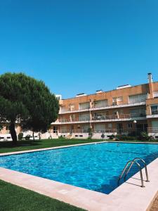 a swimming pool in front of a building at Descanso, Mar & Conforto in Esposende
