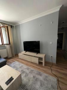a living room with a flat screen tv on a wall at Rain Suite in Istanbul
