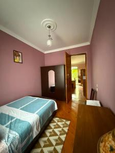 a bedroom with a bed and a table in it at Maryams Studio Guesthouse in Zugdidi