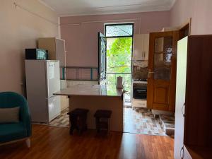 a kitchen with a large island and a window at Maryams Studio Guesthouse in Zugdidi