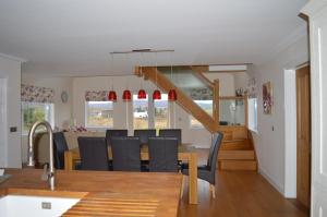 Brae Cottage في دونفيجان: غرفة طعام ومطبخ مع طاولة وكراسي
