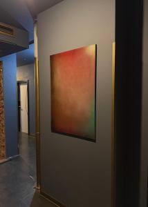 a painting hanging on a wall in a hallway at Timeout Heritage Hotel Zagreb in Zagreb