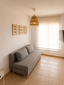 a living room with a couch and a window at El HierroStay Appartments - La Chalana & El Remo in La Restinga