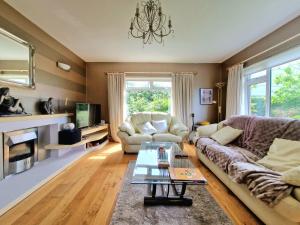 a living room with a couch and a table at Coastal Harmony B&B in Portstewart
