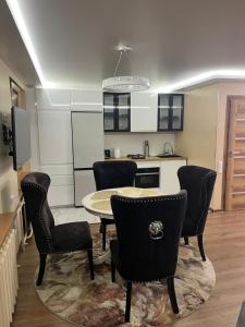 a kitchen and dining room with a table and chairs at Ritos Namai in Druskininkai