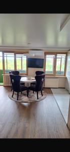 a living room with two chairs and a table at Ritos Namai in Druskininkai