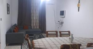 a living room with a couch and a table and chairs at Belle vue in Aïn Draham