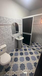 a bathroom with a toilet and a sink at Finca Las Marias A&M in Restrepo +27 photos