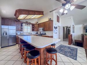 a kitchen with a large island with bar stools at Bear Lake Ranch with Bear Lake Access in Garden City