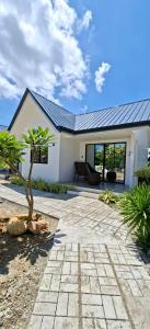a house with a patio and a tree in front of it at Plato De Ciudad II in Boracay