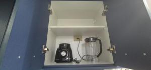a small cabinet with a blender in a room at Praia do Forte - AP DA PAZ in Cabo Frio