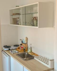 a kitchen with a sink and a counter top at Saint Sunday in Kamenari +4 photos