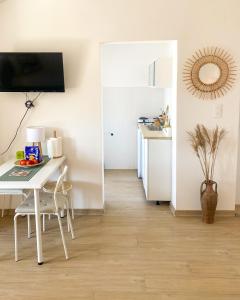 a room with a white table and a table and a kitchen at Saint Sunday in Kamenari
