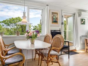 a dining room with a table and chairs and a window at 4 person holiday home in Allinge in Allinge