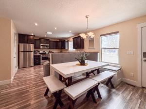 a kitchen and dining room with a table and benches at Bear Lake Bungalow in Garden City