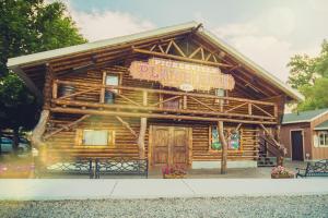 a log building with a sign on it at Bear Lake Bungalow in Garden City