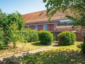 a brick building with bushes in front of it at Charming Retreat in Ringkobing in Ringkøbing