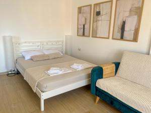 a bedroom with a bed and a chair at Saint Sunday in Kamenari