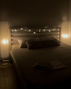 a bedroom with a large bed with lights on it at Saint Sunday in Kamenari