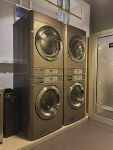 a group of four washing machines in a room at Chillout Hostel Zagreb in Zagreb