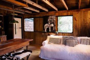 a living room with a couch and a table at Borgo 28 Gramado in Gramado
