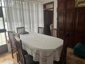 a dining room table with chairs and a white table cloth at Alojamiento Rosales in San Antonio