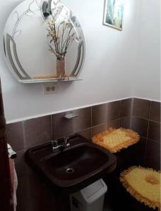a bathroom with a sink and a mirror at Alojamiento Rosales in San Antonio