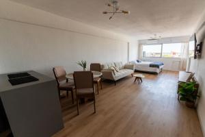 a living room with a table and a couch at Monoambiente amplio , moderno y super completo in Montevideo