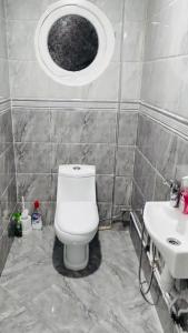 a bathroom with a toilet and a sink at مفروشة السعادة in Tlemcen