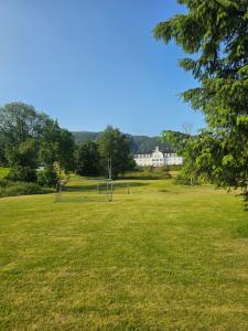 an empty field with soccer nets in the grass at Sauda Fjord Camping in Saudasjøen +29 photos