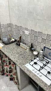 a kitchen with a stove and a counter top at مفروشة السعادة in Tlemcen