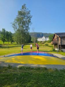 a group of people standing on top of a large object at Sauda Fjord Camping in Saudasjøen