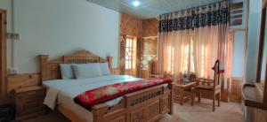 a bedroom with a large bed and a chair in it at Turgil Green Resort in Nomal