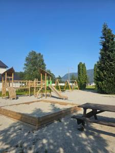 a playground with a bunch of play equipment at Sauda Fjord Camping in Saudasjøen