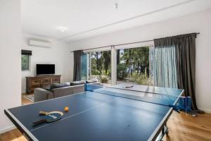 a living room with a ping pong table at Coastal Tree Top Views in Aireys Inlet