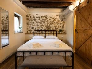 a small bedroom with a bed and a wooden wall at Casa Runcis in Cavasso Nuovo
