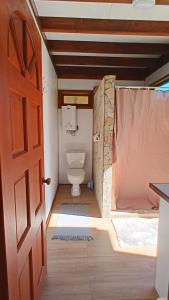 an open door to a bathroom with a toilet at Chalet Familiale Vue Mer et Coucher de Soleil Moorea in Moorea +10 photos
